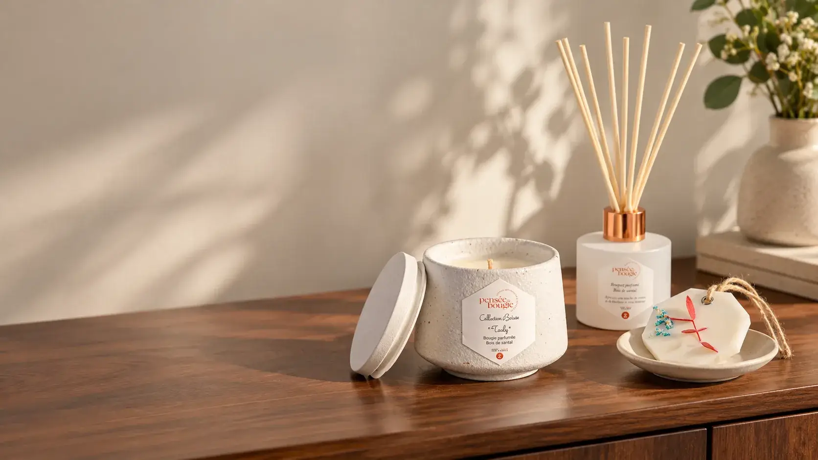 Bougie, diffuseur et fondants parfumés sur buffet en bois